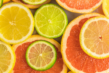 Fototapeta na wymiar Grapefruit, lime, lemon, and orange slices background