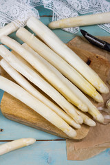 White asparagus, isolated. Blue wooden background. 