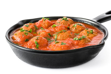 Meatballs with tomato sauce in iron frying pan isolated on white background

