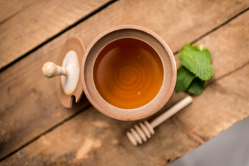 Honey Pot with Dripping Liquid Honey From Above