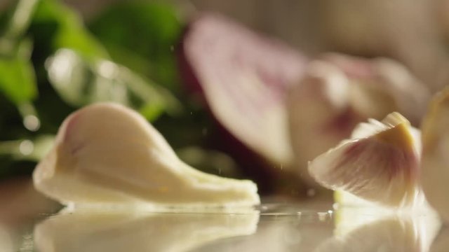 Cloves of garlic fall on glass RAPID 100fps (FEW SHOTS)