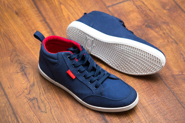 Blue sneakers on a wood background
