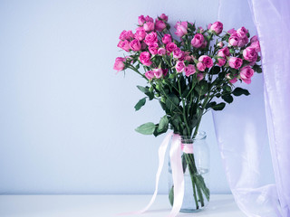 Pink bouquet of roses on the table