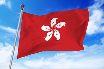 Flag of Hong Kong developing against a clear blue sky