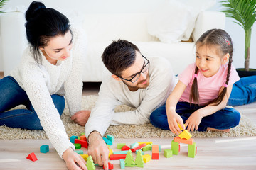 Family playing with toy blocks