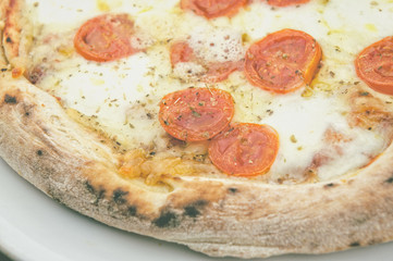 Pizza with fresh tomatoes and mozzarella closeup