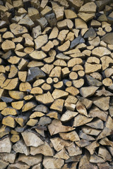 Background, texture of wooden chipped logs of different sizes