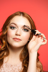 Young woman applying make up