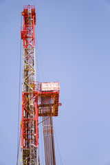 drilling rig mast in a blue sky background