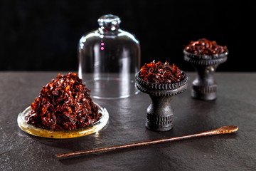  black ceramic bowl for hookah is filled with shisha 
