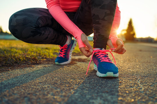 Running shoes - woman tying shoe laces