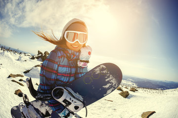 Girl snowboarder enjoys the ski resort