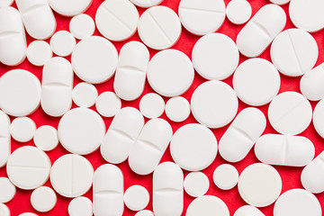 Abstract background made of white pills on red background