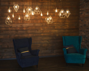 Incandescent retro Edison's lamps in a modern style interior with two armchairs