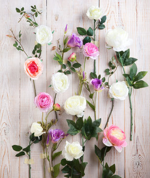 White roses composition on wooden wall. Wedding background of beautiful roses, vintage style