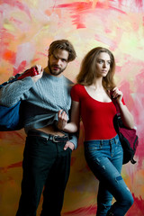 Pretty girl with backpack and bearded man with bag