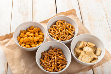 Pretzels in bowls on wooden table from above