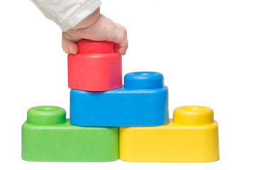 Toddlers hand playing with large toy bricks