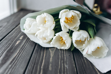 Mother's Day . white tulips on dark  wooden background