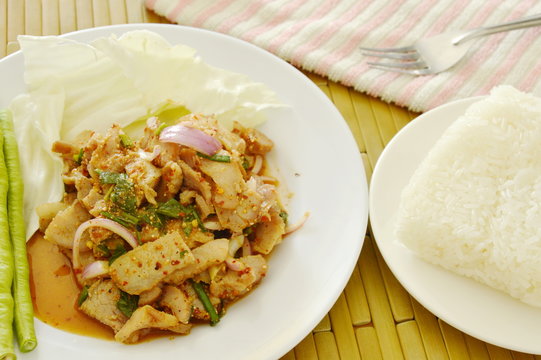 sticky rice eat couple with Thai spicy slice pork salad and fresh vegetable