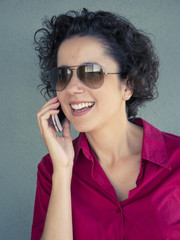 Beautiful woman laughing and talking on the cell phone