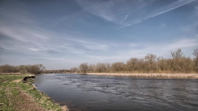 River in eastern Europe, clouds moving in the sky. UHD HDR time lapse footage. Beauty of European landscape. 