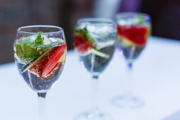 Cocktail with strawberries, mint and bubbles. Beverages background