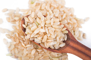 Brown rice in a wooden spoon