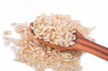 Brown rice in a wooden spoon
