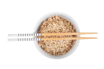 Brown rice with chopsticks on white background
