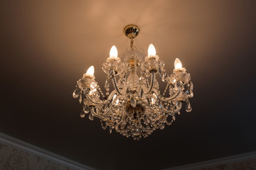 Ceiling lamp in crystal with lighted lamps