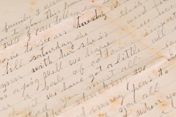 Naklejka premium Vintage distressed aged handwritten letters with a shallow depth of field background