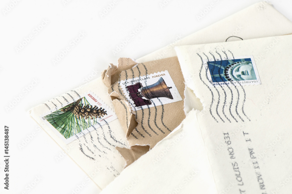 Wall mural forever stamps on opened envelopes background isolated on white