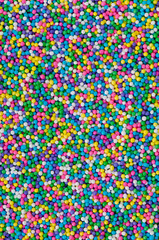 Bright and colorful nonpareils sprinkles background