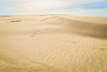 Moving colorful sand dunes in a sunny day