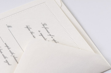 White formal invitation RSVP card and envelope isolated on white