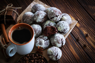 Chocolate cookies and cup of coffee with coffee bean, cocoa powder, cinnamon and star anise on...