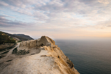 Fototapeta premium Sea and rock at the sunset. Nature composition.