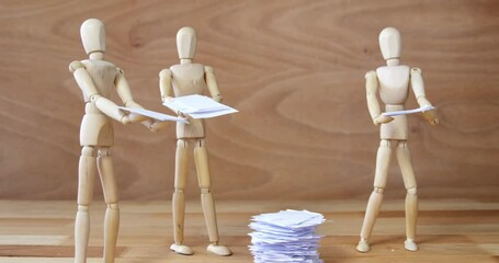 Business wooden figurine standing and holding document
