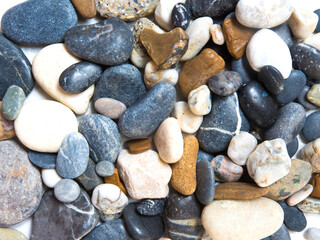 Marine multicolored stones pattern on a light background Flat lay