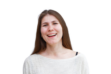 Portrait of a laughing young woman in a light jumper looking directly into the camera isolated on white background. Demonstration of various emotions.