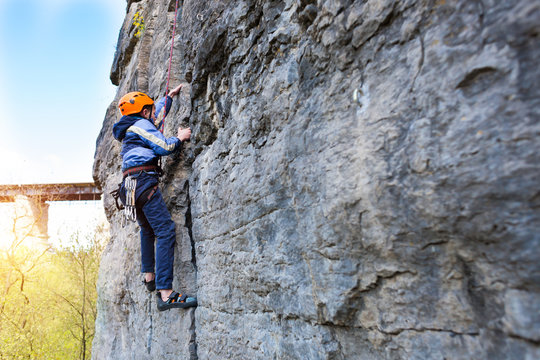 Kid Rock Climber Climbs The Cliff.