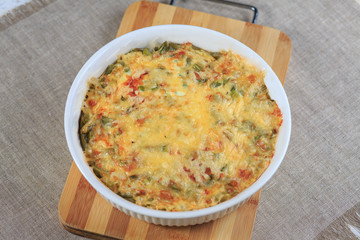 Meat vegetables pie and with cheese on a plate on a gray background