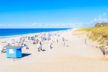 Wicker chairs on sandy beach in Kampen village, Sylt island, Germany