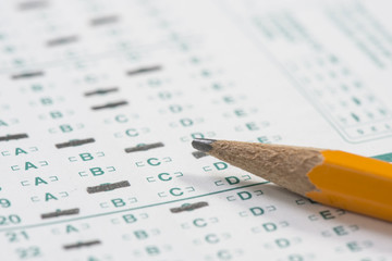 Close up of a standardized test form with a pencil resting on it with a shallow depth of field - obrazy, fototapety, plakaty