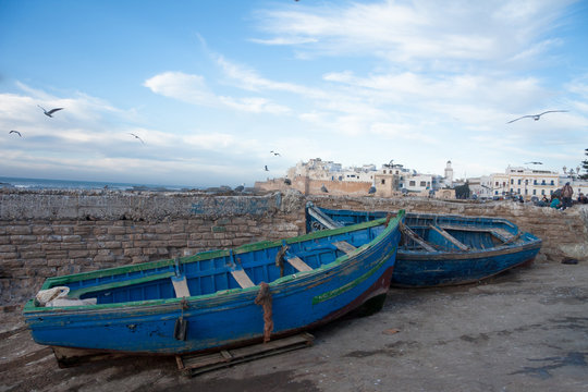 MOROCCO, ESSAOUIRA - January 09, 2013. Fishing blue boats in port of Essaouira harbour with fishmens.