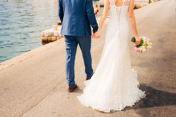 Fototapeta na wymiar Female and male feet on the dock. Wedding in Montenegro