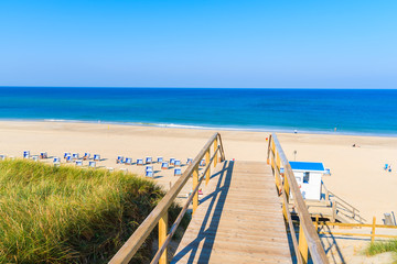 Wooden steps from sand dune to beautiful Westeland beach, Sylt island, Germany