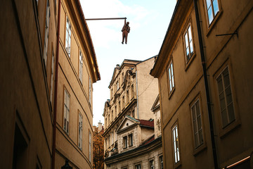 Fototapeta na wymiar Art object of art in Prague. Hanging on the facade of the house