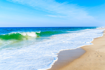 Fototapeta na wymiar Sea waves on white sand beautiful beach near Kampen village, Sylt island, Germany